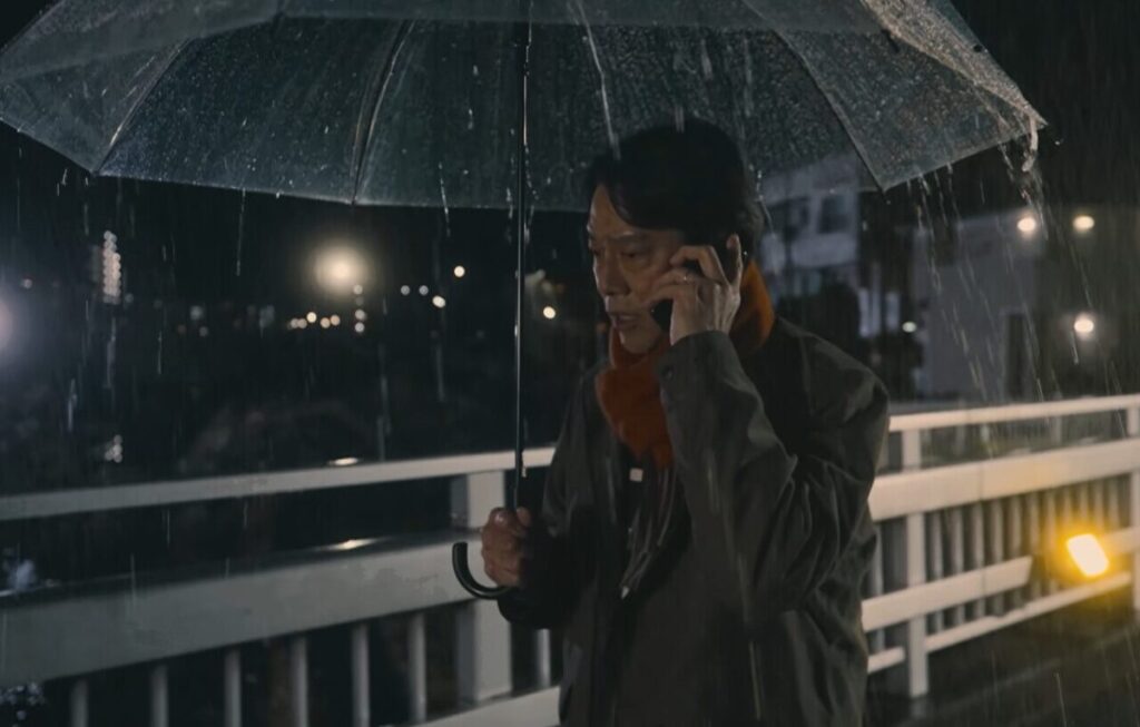 ドラマ「妻、小学生になる。」第4話、雨の中、白石万理華(毎田暖乃)に電話をかけている新島圭介(堤真一)